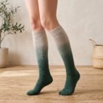 Merino wool compression socks in green gradient knee-high design