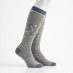 Merino wool compression socks in gray with navy accents and mountain pattern