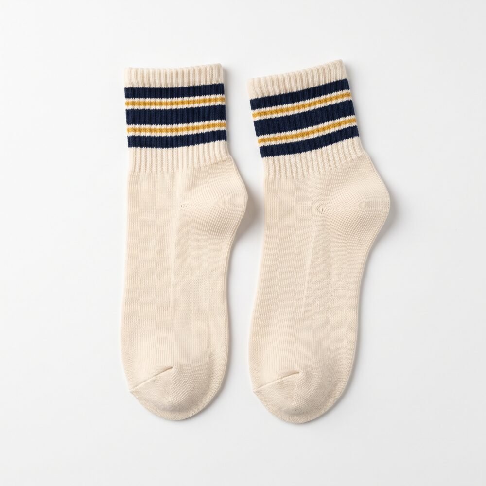 Pair of cream ankle socks with navy blue and gold striped cuffs
