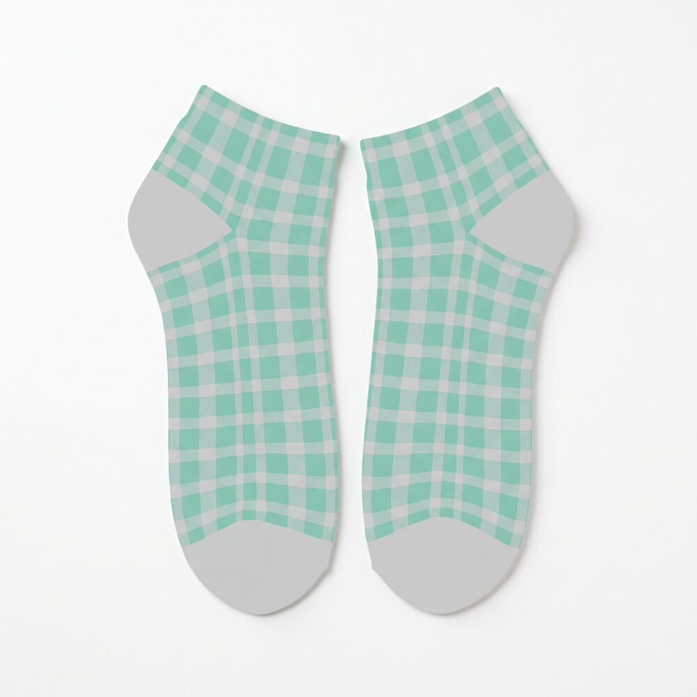 Pair of mint green and white checkerboard ankle socks with gray heel and toe panels on a white background