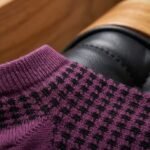 Purple and black patterned ankle socks with ribbed cuffs displayed on a white background