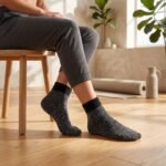 Black speckled ankle socks with ribbed cuffs displayed on a white background