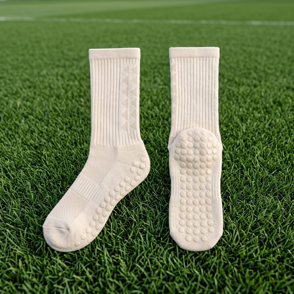 Cream Grip Socks with non-slip traction dots worn on artificial football field