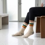Lehvera merino wool hiking socks with cream base and colorful teal yellow and orange stripes