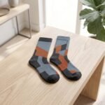 Lehvera merino wool hiking socks with black gray and orange geometric design
