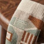 Merino wool compression socks with geometric green beige and rust pattern