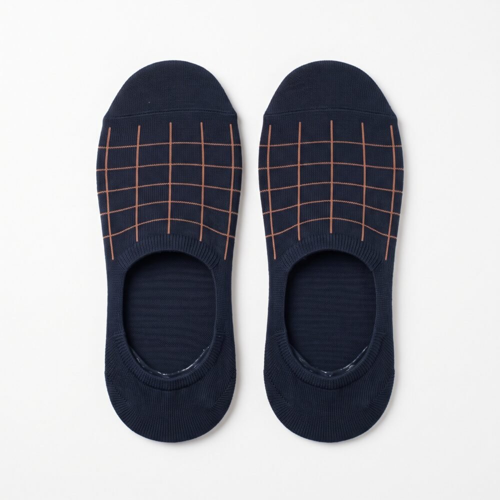 A pair of dark navy blue no show socks featuring a copper windowpane grid pattern across the top, laid flat against a clean white background.