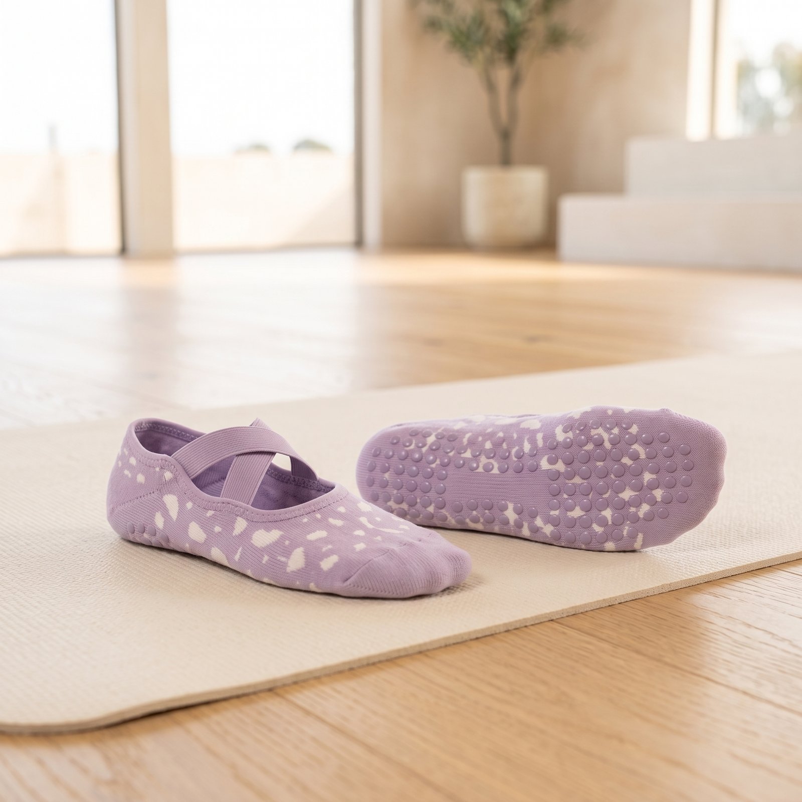Pilates Socks with Non-Slip Grip Sole Pilates socks with cross strap design and non-slip grip soles on a Pilates mat