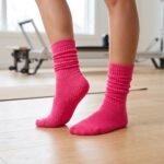 Bright pink pilates socks with non-slip grip dots on the soles for studio workouts