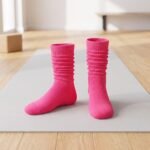 Bright pink pilates socks with non-slip grip dots on the soles for studio workouts