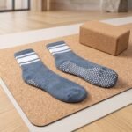 Blue and white striped pilates socks with non-slip grip dots on the soles