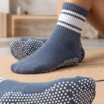 Blue and white striped pilates socks with non-slip grip dots on the soles