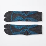 A pair of dark grey crew-length Tabi socks featuring a bright blue abstract wireframe pattern, laid flat against a crisp white background.