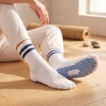 Women’s white and navy crew grip socks with non-slip soles for Pilates and yoga