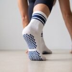 Women’s white and navy crew grip socks with non-slip soles for Pilates and yoga