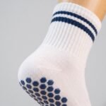 Women’s white and navy crew grip socks with non-slip soles for Pilates and yoga
