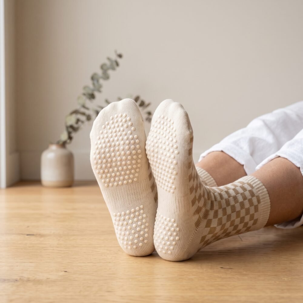 Woman wearing cream and tan checkered women’s crew grip socks with non-slip grip soles