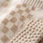 Woman wearing cream and tan checkered women’s crew grip socks with non-slip grip soles