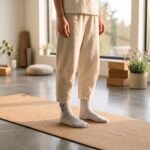Woman wearing cream and tan checkered women’s crew grip socks with non-slip grip soles