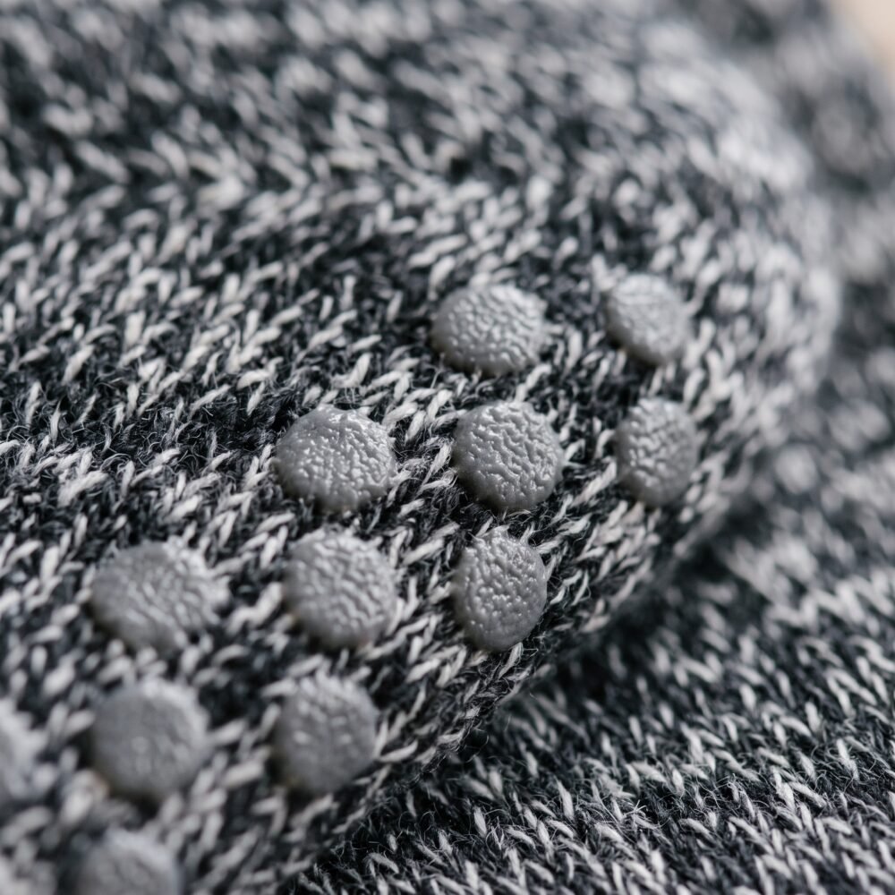 Women’s black and gray crew grip socks with full non-slip sole grip pattern
